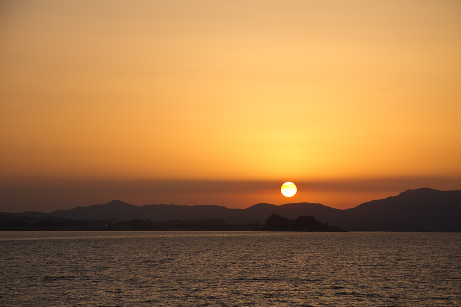 Sun setting behind island of Corfu (Kerkyera)